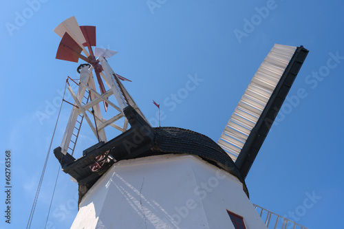 a beautiful anchient white windmill in aarsdale, Bornholm on a sunny day with blue sky photo