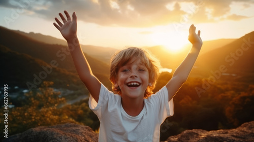 Boy kid wearing a white t-shirt joyfully raises his arms, his vibrant energy shining against a captivating nature landscape at sunset , portraying an aura of positivity and exuberance
