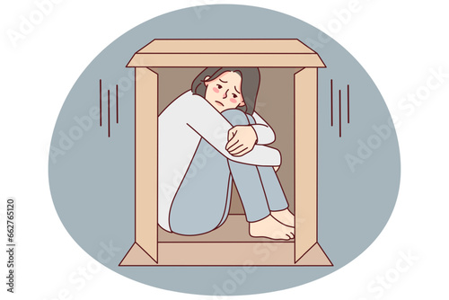 Unhappy young woman sit in box suffer from sociophobia. Upset girl hide in cardboard parcel struggle from loneliness or solitude. Vector illustration.