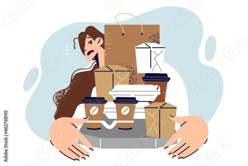 Woman holds boxes and bags for take-out food working as delivery courier at fastfood restaurant