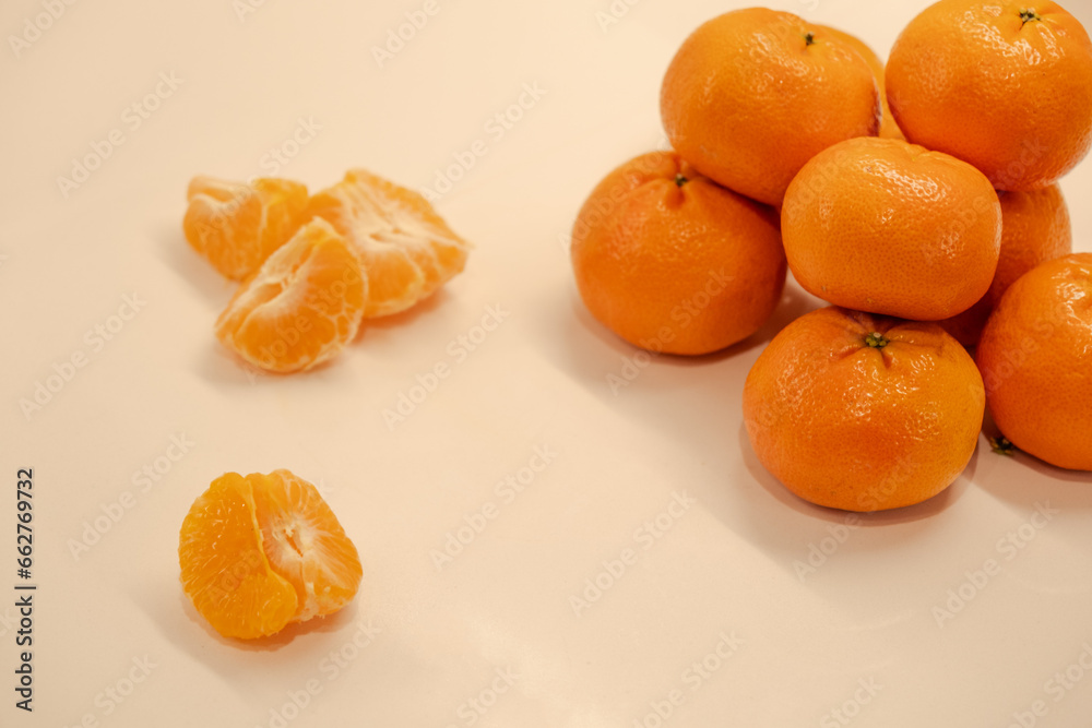 Several tangerine fruits on the table, healthy food and snacks, mandarin orange slices Several tangerine fruits on the table, healthy food and snacks, mandarin orange slices