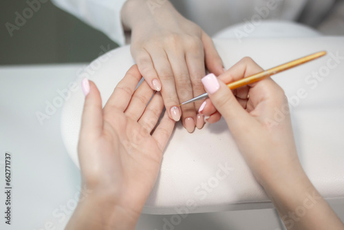 professional manicurist install diamond on the client's nails