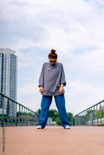 young street hip hop dancer in sportswear doing warm up before dance rehearsal hobby active lifestyle