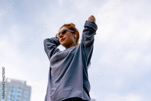 young street hip hop dancer in sportswear doing warm up before dance rehearsal hobby active lifestyle