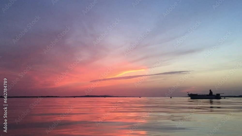 Boat crossing a tranquil sunset sea and sky Boat crossing a tranquil sunset sea and sky
