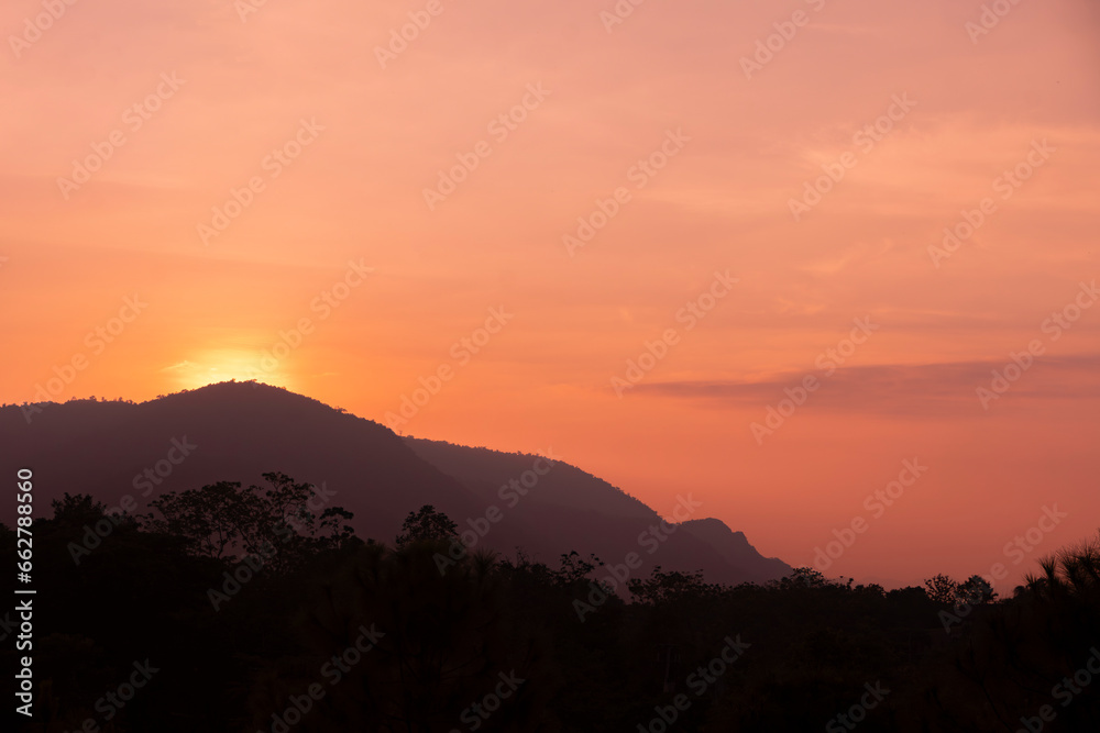 Silhouette of mountain forest at sunset. Hot weather. Climate change.
