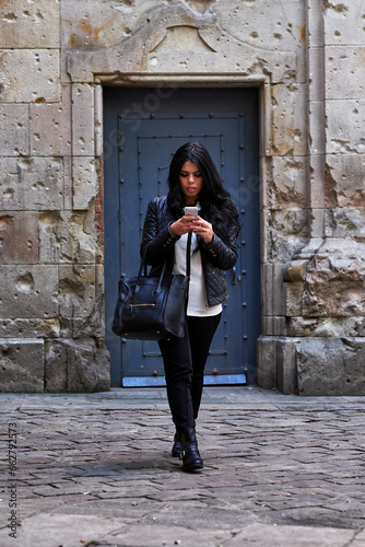 Young woman using a smartphone on the street