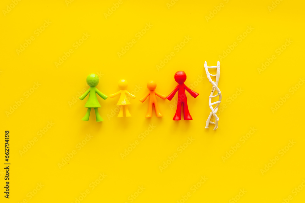 DNA molecule with rubber figurines of people. Heredity of family members