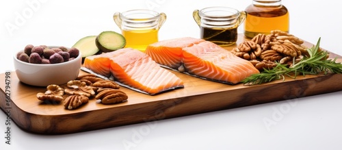 Choosing omega 3 and unsaturated fat rich foods like almonds pecans hazelnuts walnuts olive oil fish oil and salmon is beneficial for a healthy diet due to their high vitamin E content and d photo