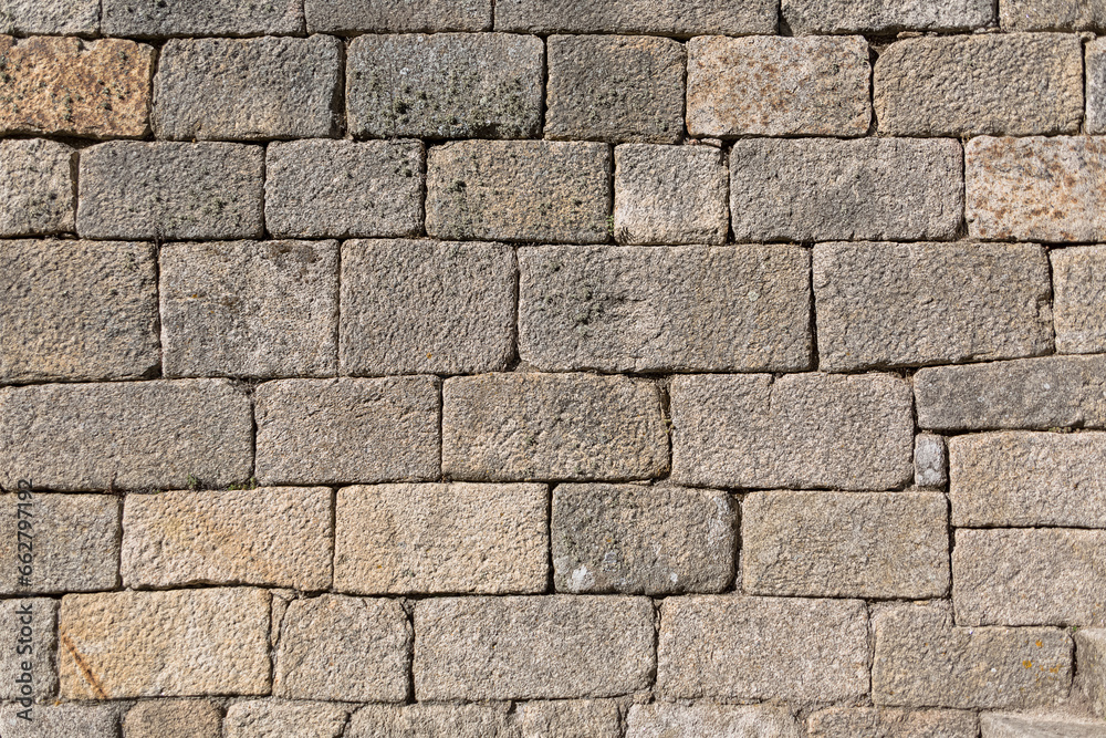 Architecture textures, detailed view of a traditional paired granite masonry, used on a ancient walls Architecture textures, detailed view of a traditional paired granite masonry, used on a ancient walls