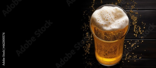 Foto Beer lover s thumb imprint on foamy glass viewed from above With copyspace for t