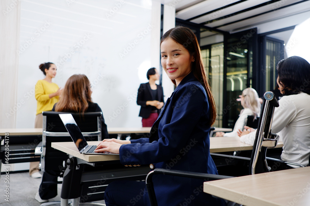 A team of business people sits in a meeting to plan an event. A team of business people sits in a meeting to plan an event.