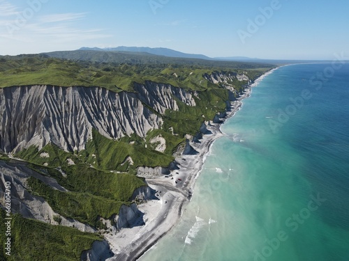 Aerial shot of white rocks and coastline of Iturup Island, Kuril islands