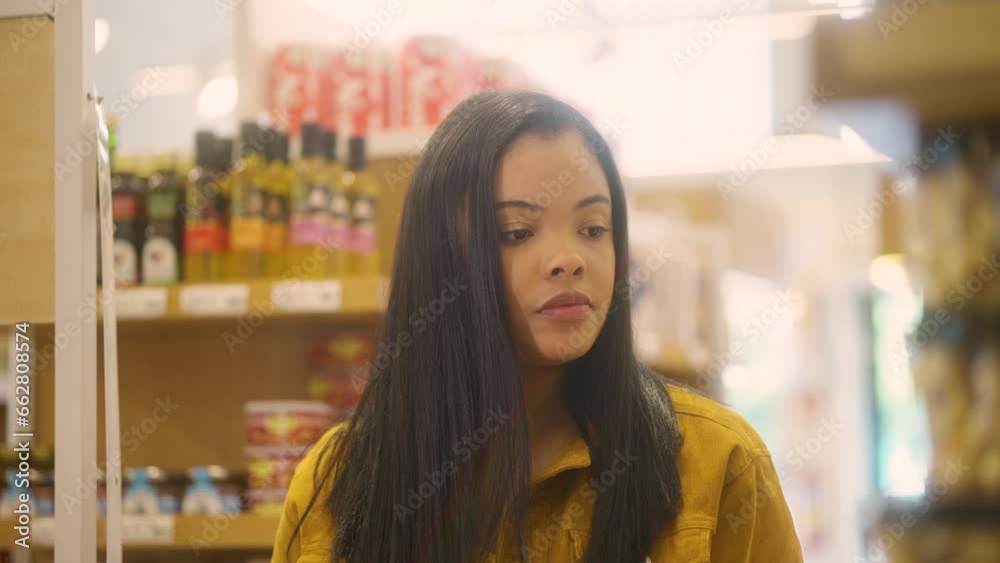 Walking the aisle and shopping. young black brazilian woman Picking product in market. Walking the aisle and shopping. young black brazilian woman Picking product in market.