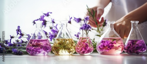 Beauty scientists in a lab extract organic essences from flowers in flasks to create medicinal products for health and beauty With copyspace for text