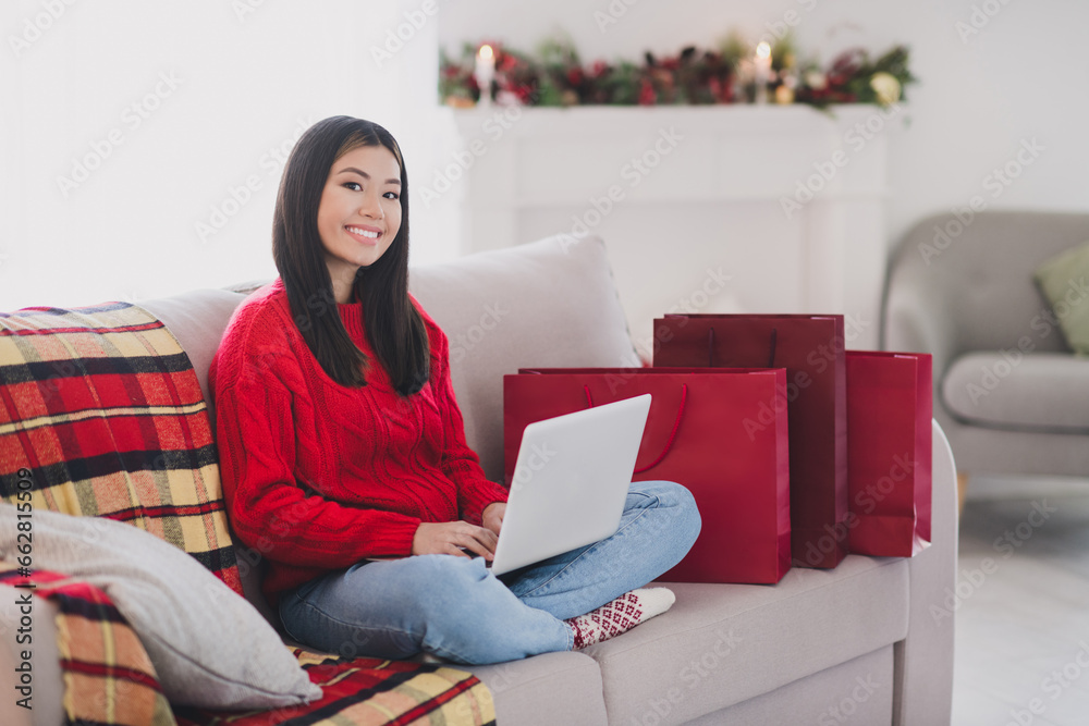 Photo of dreamy cheerful lady dressed knitted x-mas sweater typing wishes modern gadget indoors house room Photo of dreamy cheerful lady dressed knitted x-mas sweater typing wishes modern gadget indoors house room