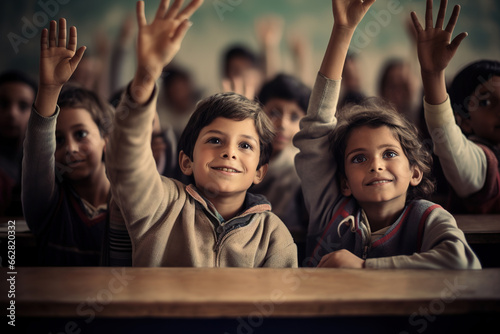 Pupils raising their hands during class at the elementary school.