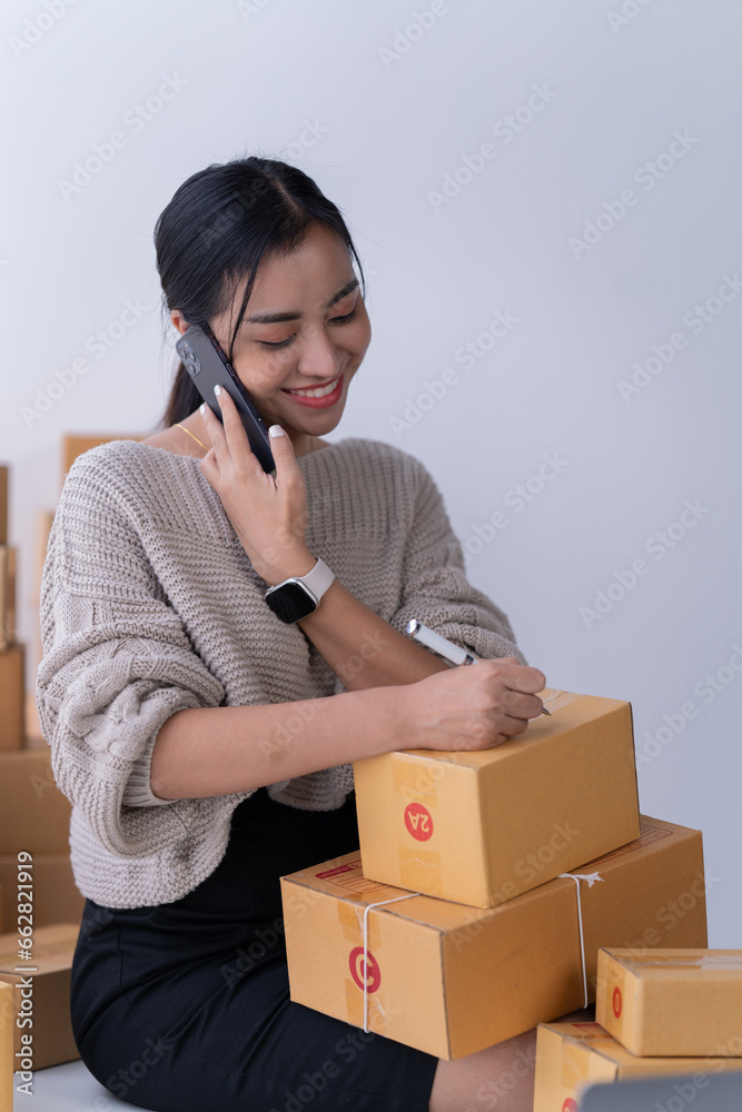 startup girl Small SME business owners work with laptop computers at work. with parcel paper boxes for delivery to customers online selling, Ecommerce, startup girl Small SME business owners work with laptop computers at work. with parcel paper boxes for delivery to customers online selling, Ecommerce,