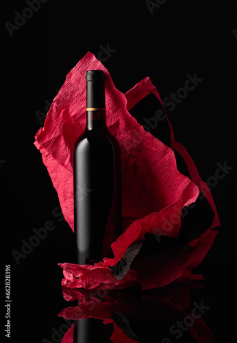 Bottle of red wine on a crumpled paper.