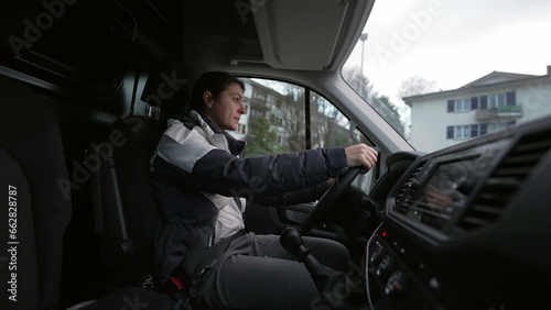 Woman driving truck, interior perspective of a female driver drives large vehicle, hands on steering wheel