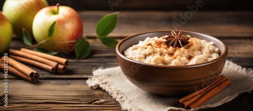 Delicious apple cinnamon porridge Natural breakfast on wooden table With copyspace for text