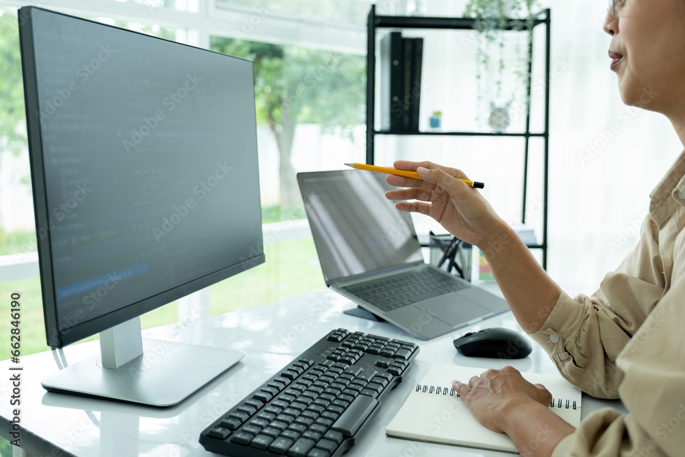 Female IT programmer innovates at office desk. Female IT programmer innovates at office desk.