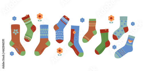 Set of knitted warm socks of various colors and patterns in red, green, blue, brown tones. Autumn-winter collection of accessories for elegant women's and children's looks. Vector illustration. 