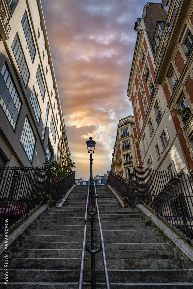Low angle of a staircase between residential buildings in Montmartre, Paris, Frane at sunset