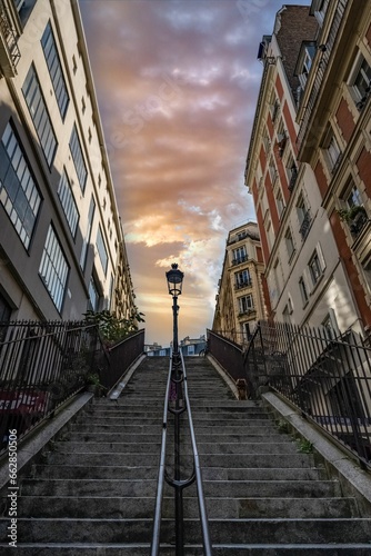 Low angle of a staircase between residential buildings in Montmartre, Paris, Frane at sunset