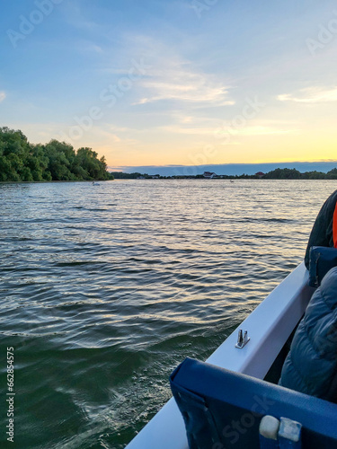 Tourists take a sunrise boat tour through the Danube Delta Biosphere Reserve, Delta Dunarii near Tulcea, Wallachia, Romania, Donaudelta © GrebnerFotografie