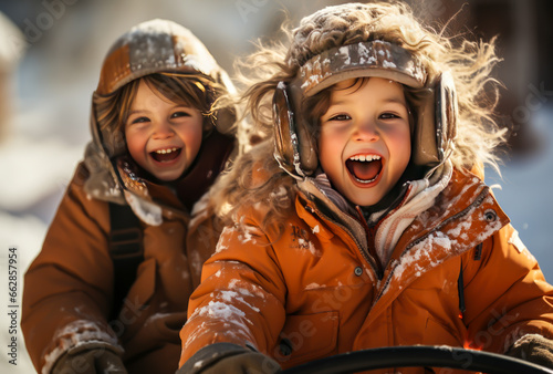 two girls are playing sledding in the snow, they are screaming with excitement.