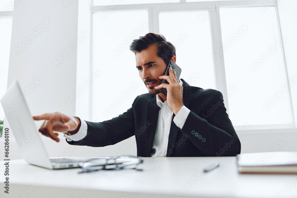 Obraz premium Businessman man smile conversation winner computer phone suit talk caucasian happy technology laptop office