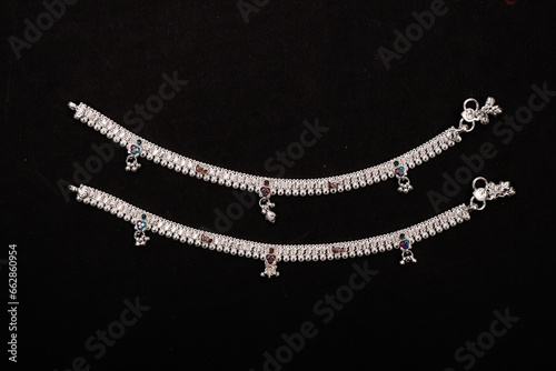 Indian Silver Anklets Jewellery Isolated On Black Background. photo