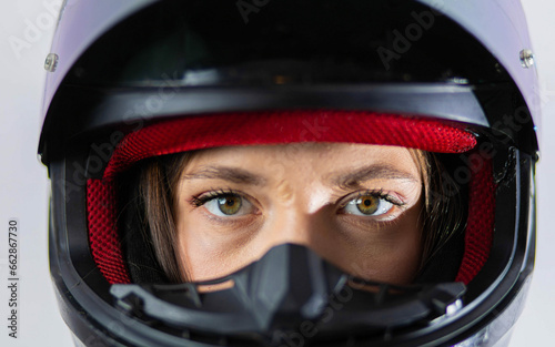 woman in a motorcycle helmet close-up on a white background. Woman motorcyclist  © velimir
