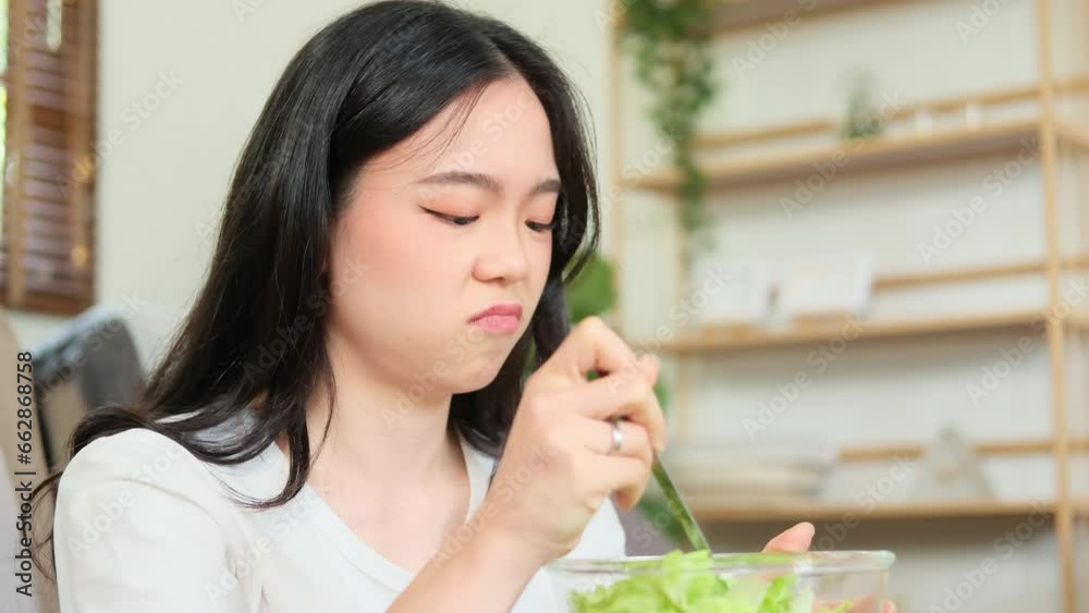 woman sitting at table, feeling unhappy with diet not wanting to eat salad woman sitting at table, feeling unhappy with diet not wanting to eat salad