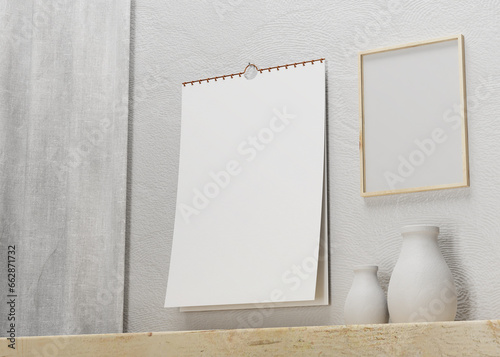 potrait wall calendar and poster beside it inside a room, suitable for calendar design presentation