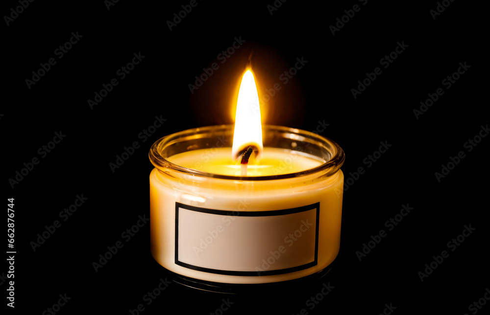 candle in a glass jar with blank label isolated on black background - mock up template with copy space candle in a glass jar with blank label isolated on black background - mock up template with copy space