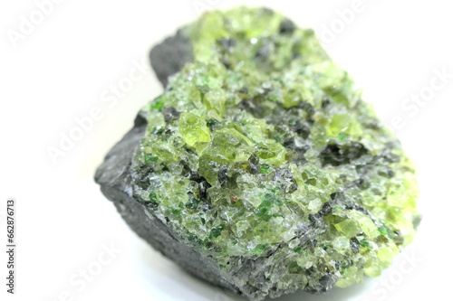 Natural olivine minerals crystallization of which the best pieces is called peridot and used for semi-precious jewelry stones