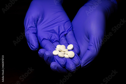 Doctor holding pile of pills