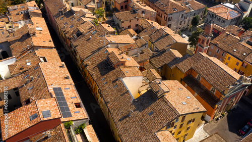 Aerial view of the sloping roofs of the houses in the historic center of Reggio Emilia, Italy. The orange color of traditional roofs predominates. © Stefano Tammaro