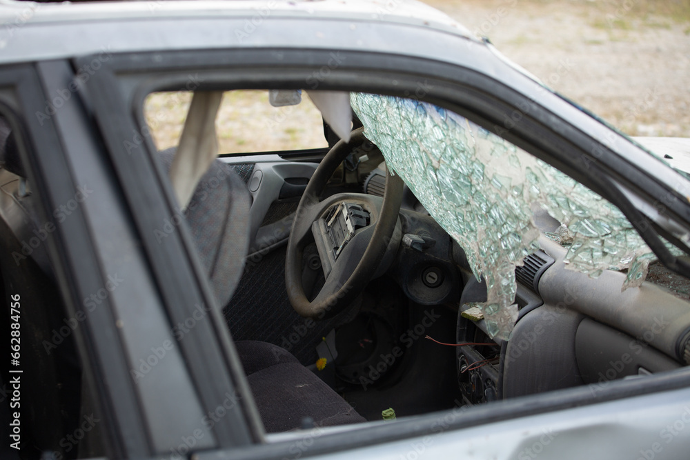 abandoned car with broken windscreen