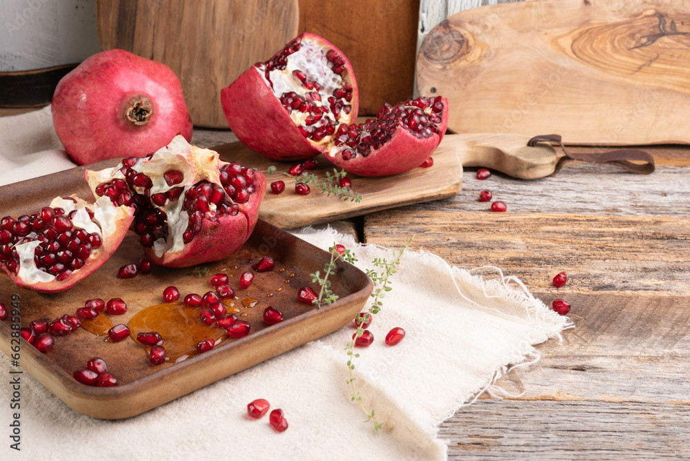 Fresh, ripe pomegranate on a wooden background.