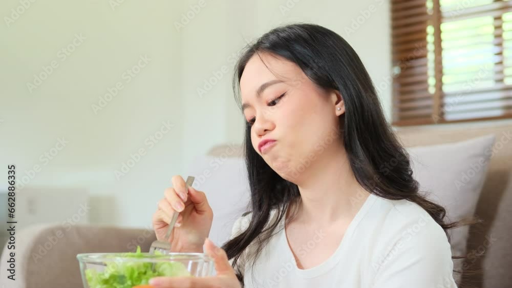 woman sitting at table, feeling unhappy with diet not wanting to eat salad woman sitting at table, feeling unhappy with diet not wanting to eat salad
