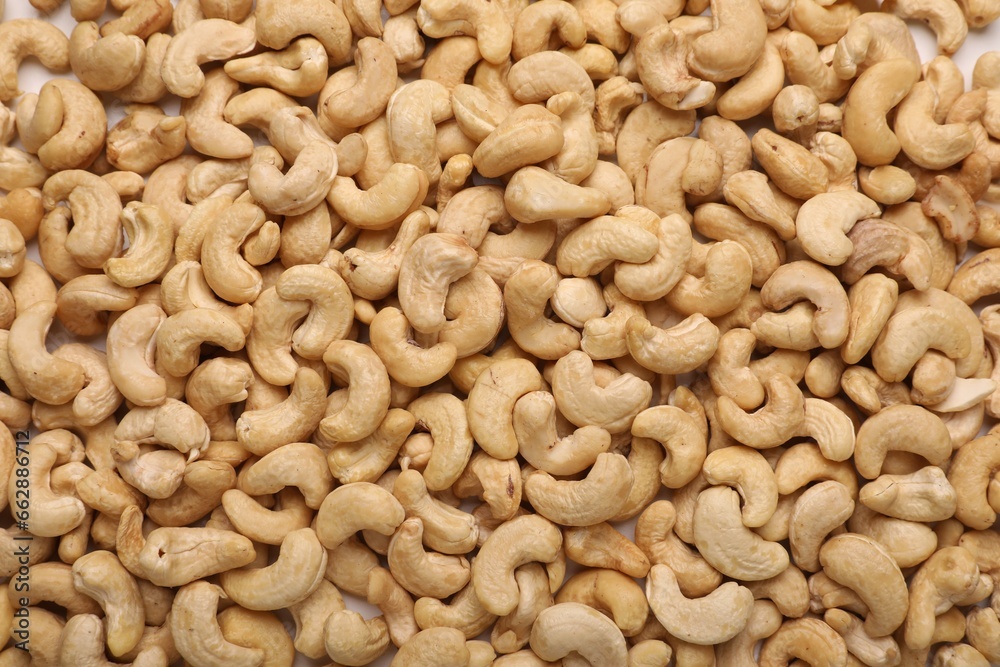 Many tasty cashew nuts as background, top view Many tasty cashew nuts as background, top view
