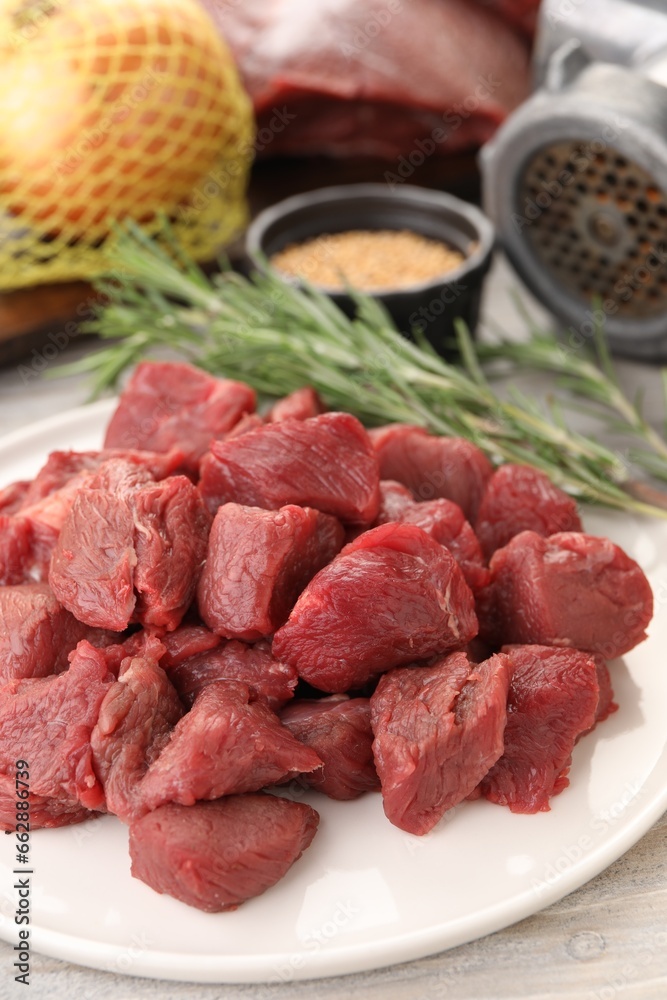 Pieces of beef on white wooden table, closeup