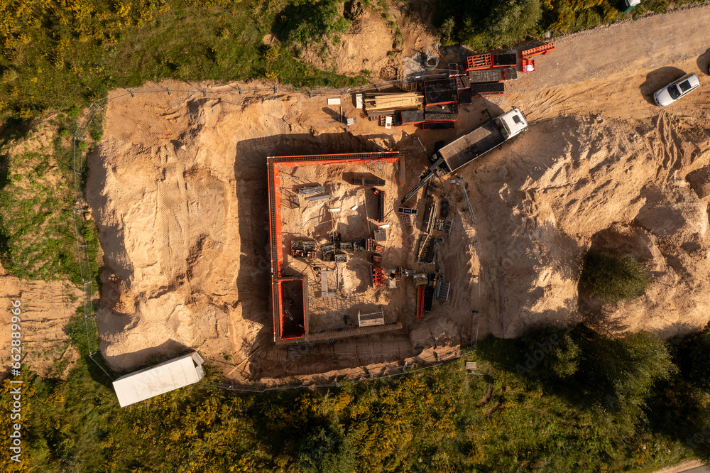 Drone photography of small construction site and workers building a building