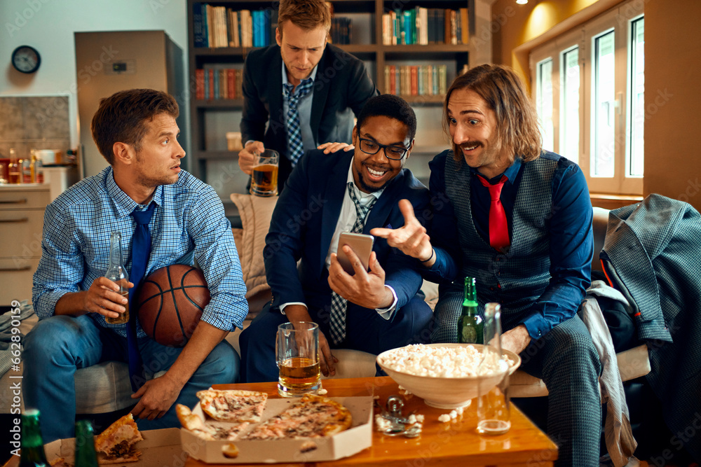 Young and diverse group of friends using a smartphone while watching a basketball game on the tv in the living room - obrazy, fototapety, plakaty 