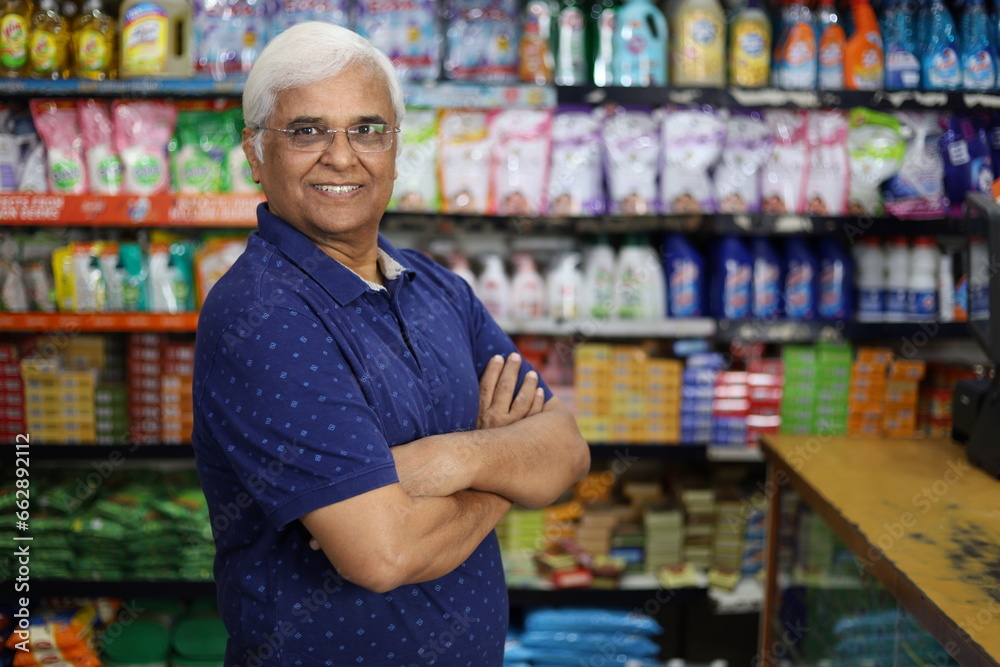 Portrait of Happy and smiling Indian old age man purchasing in a grocery store. Confident and fit Grandpa buying grocery for home in a supermarket.
