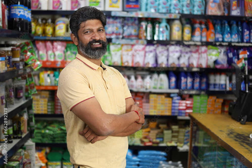 Beautiful portrait of handsome and smiling bearded man shopping and posing in hypermarket. Local mini mall happy smiles of satisfied customer.