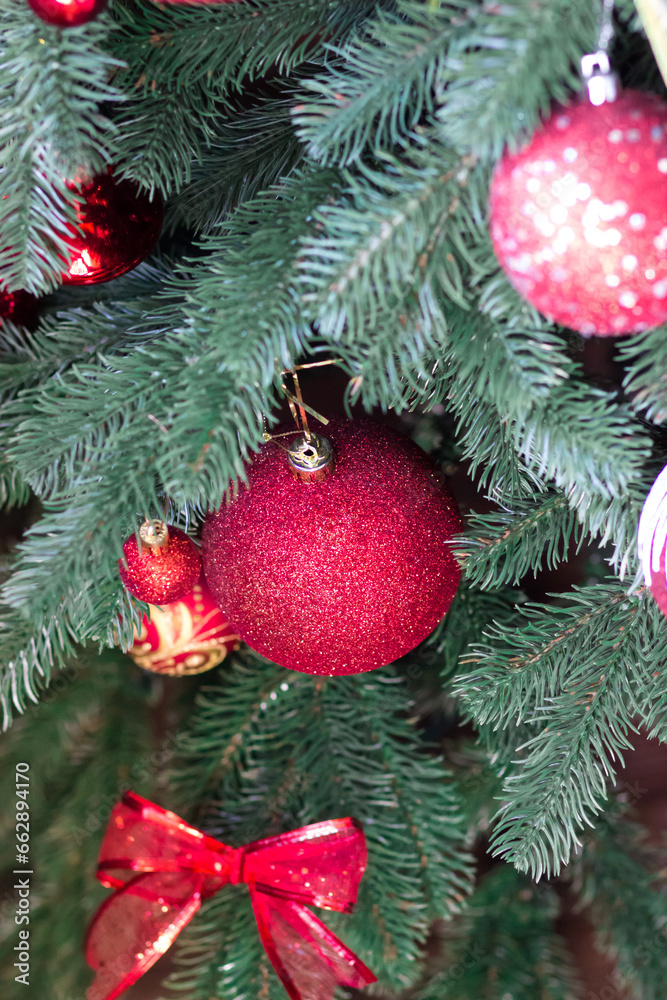 Red Christmas ball on a Christmas tree. Christmas tree. Festive interior